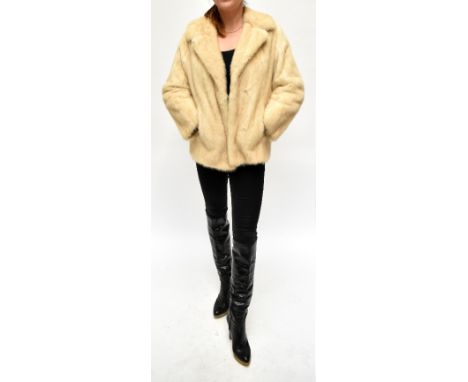 A vintage cream short mink coat with collar and back detail, two front pockets and mink coloured satin patterned lining with 