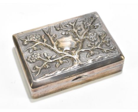 A white metal rectangular snuff box with repoussé floral decoration surrounding a vacant shield cartouche, unmarked, length 8