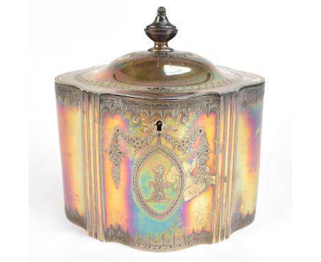 A George III hallmarked silver tea caddy of shaped oval form with chased decoration surrounding an oval cartouche, with centr