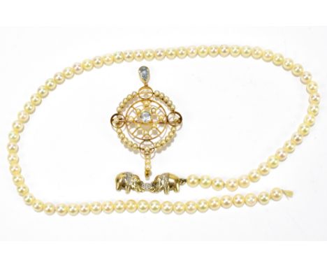 A 15ct Edwardian yellow gold seed pearl openwork pendant/brooch set with twin aquamarine coloured stones in an openwork frame