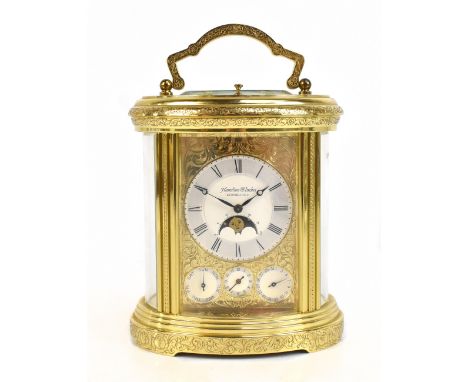 MATTHEW NORMAN FOR HAMILTON &amp; INCHES OF EDINBURGH; a good and large oval brass cased repeating carriage clock, the silver