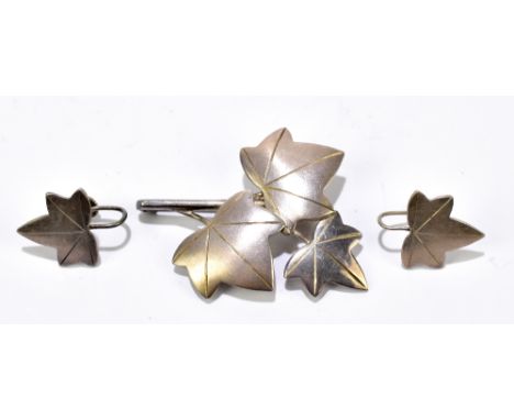 GEOFFERY BELLAMY FOR IVAN TARRANT; a modernist hallmarked silver leaf brooch, length 47mm, and a matching pair of screw back 