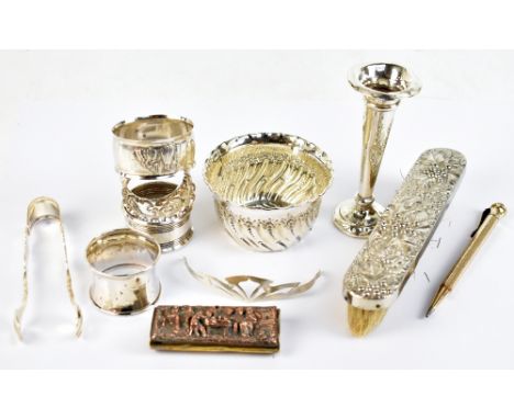 A group of silver and white metal items including a bowl with part wrythen decoration, four napkin rings, a loaded vase, a pa