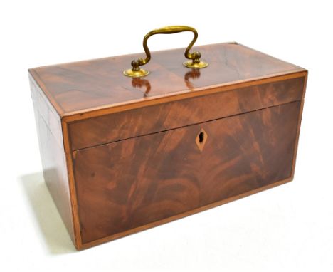 A Georgian flame mahogany tea caddy with brass swan neck handle to the cover enclosing three compartments, length 25.5cm.Addi