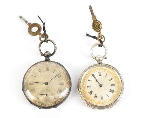 A white metal lady's fob watch, the face with engine turned detail, set with Roman numerals and subsidiary dial, with white a