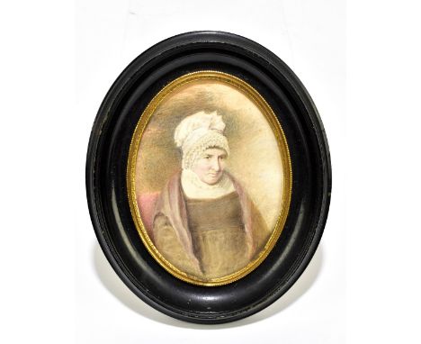 A 19th century portrait miniature, watercolour on ivory depicting a seated elderly lady, in ebonised frame, 11 x 8.5cm.