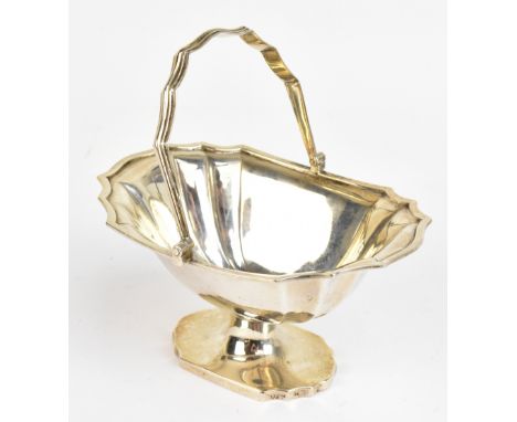 C.S HARRIS &amp; SONS LTD; an Edward VII hallmarked silver swing handled pedestal sugar basket, with panelled decoration, Lon
