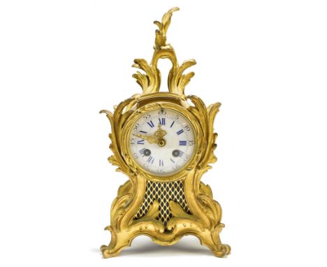 A late 19th century French ormolu Rococo-style eight day mantel clock, the porcelain dial set with Arabic and Roman numerals,