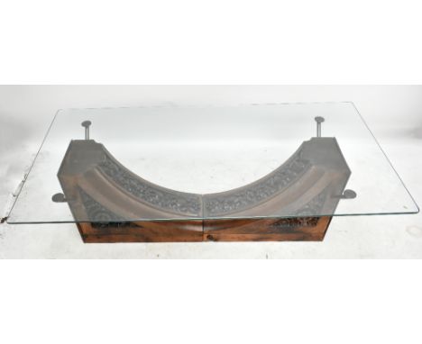 A coffee table with plate glass top on two late Victorian foliate carved oak bracket supports, height 50.8cm, the top 162.5 x