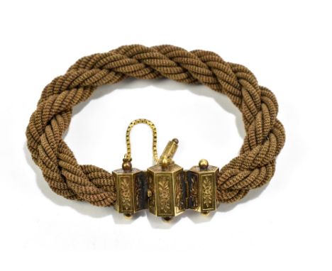 A Victorian yellow metal and braided hair mourning bracelet with safety chain.Additional InformationThere is some slight fray