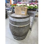 Large decorative oak metal banded whiskey barrel with decorative distillery inlaid logo on top