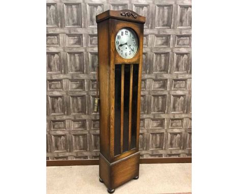 EDWARDIAN OAK LONGCASE CLOCK
the 11 inch circular silvered dial with Arabic numerals and steel hands, three front winding key