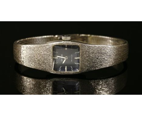 A ladies' 18ct white gold Omega de Ville mechanical bracelet watch, c.1970, with a teal blue lacquer dial, with white raised 