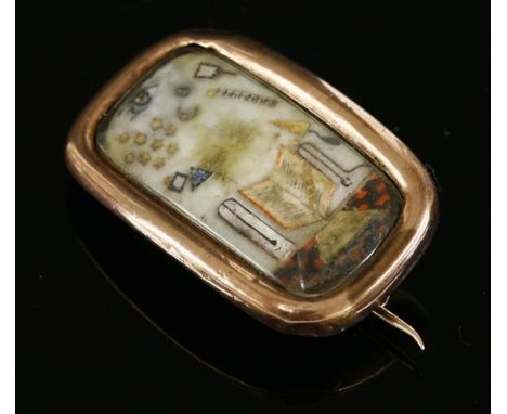 A Georgian gold cased masonic brooch of elongated cushion form, c.1800-1820, with hand painted and cut paper applied symbols 