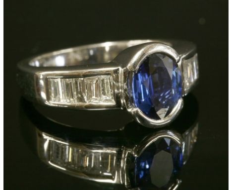 A Continental white gold, sapphire and diamond ring with an oval mixed cut sapphire, with a stated weight of 1.59ct, end set 