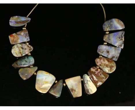 A 9ct gold boulder opal necklace, with a series of keystone and freeform pierced boulder opals, all drilled and threaded with