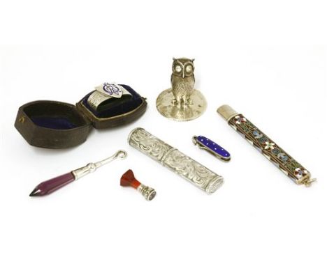 A collection of novelty items , comprising: a Sampson Morden &amp; Co. silver owl menu holder, set with white paste stone to 