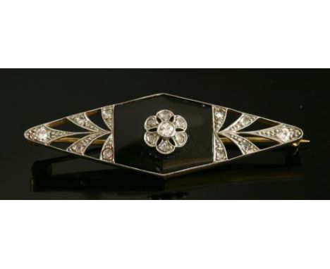 An Art Deco diamond and onyx lozenge-shaped brooch, with a central old Swiss cut diamond and rose cut diamond daisy cluster, 