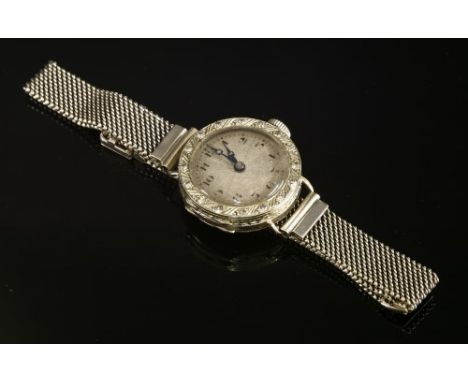 An 18ct white gold diamond set mechanical cocktail watch, c.1925, on a later white gold adjustable mesh bracelet, the circula