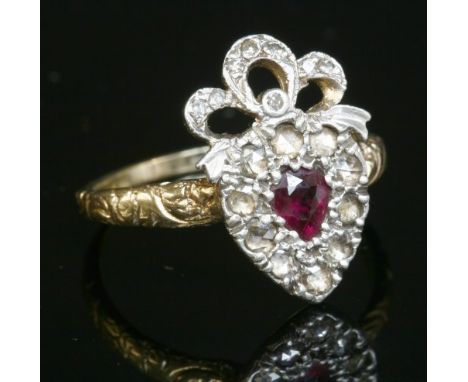 A Georgian-style ruby and diamond heart and bow cluster ring, with a pear cut ruby surrounded by a row of rose cut diamonds. 