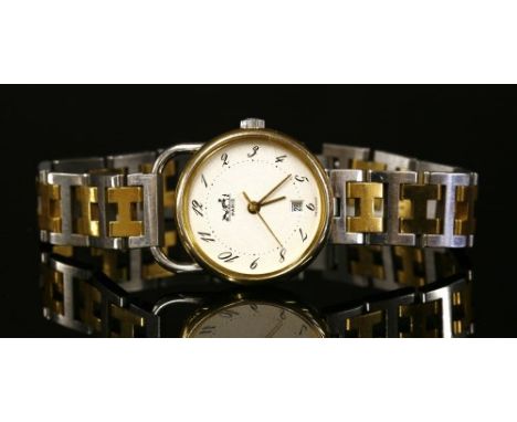 A ladies' bicolour Hermès quartz 'Arceau' bracelet watch, c.1990, with a circular case 25mm diameter. Textured champagne dial
