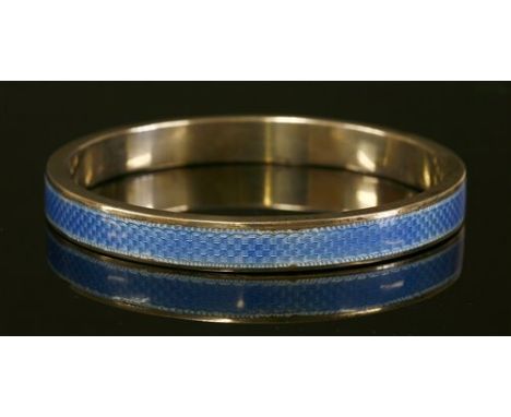 An Art Deco silver slave bangle, by Henry Matthews, of hollow flat section form, with cornflower blue guilloché enamel decora