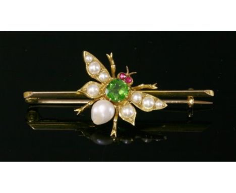 An Edwardian gold, green paste, ruby and split pearl set insect bar brooch, c.1905, a faceted green paste, set in a cut down 