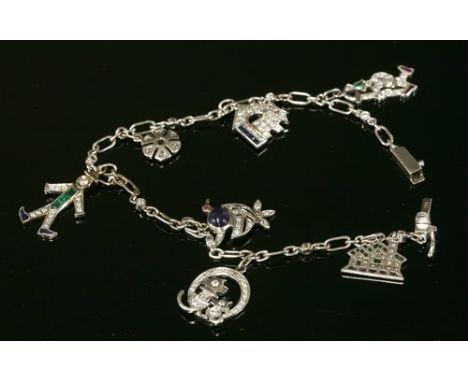 A white gold Art Deco-style sapphire, emerald, ruby and diamond set charm bracelet, with a series of brilliant cut diamonds, 