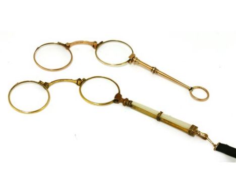 A pair of gold lorgnettes, the tapering handle with engraved scallop decoration, terminating in a ring marked '10ct SM', 25.8