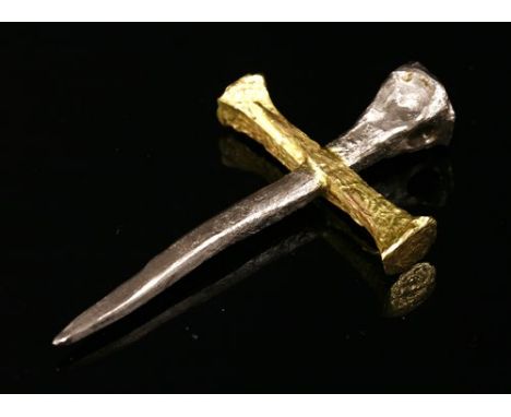 A yellow and white gold cross by Kim Gioielli, c.2005, of overlapping handmade nail form, with a textured finish. Tested as a