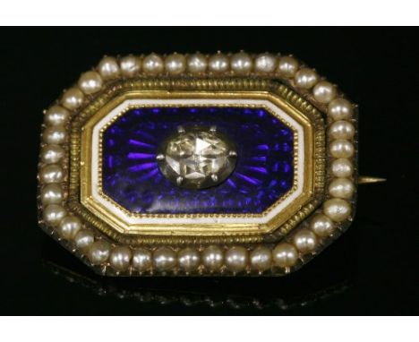 A Georgian diamond, enamel and seed pearl brooch, with an oval rose cut diamond, foiled and set to a cut down collet. A blue 