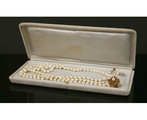 A single row uniformed cultured pearl necklace , strung knotted continuous to a 9ct gold cultured pearl and ruby two row sepa
