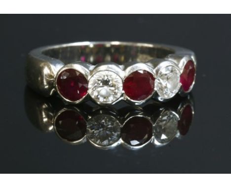 A platinum, five stone ruby and diamond half eternity ring, by Cellini, with three circular mixed cut rubies and two brillian