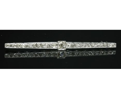 An Art Deco white gold diamond set bar brooch, c.1925, with an old European cut diamond, milligrain set to a box collet at th