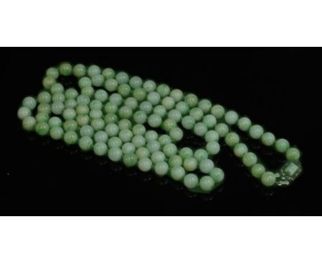 A single row uniform jade bead necklace, with one hundred and seven beads, 9 to 9.5mm in size, strung knotted to a Continenta