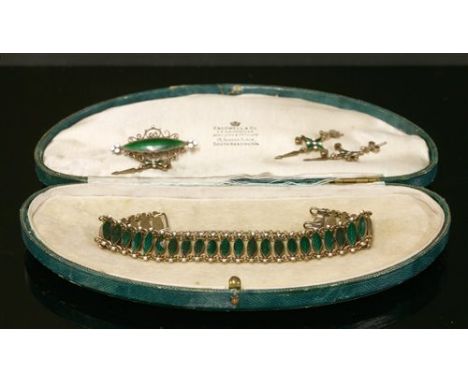 A Norwegian silver and enamel brooch, c.1910, with a marquise-shaped central plaque with green guilloché enamel decoration. A