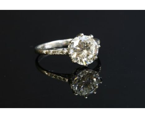 A single stone diamond ring, with diamond set shoulders, with a brilliant cut diamond, estimated as approximately 2.19ct, cla