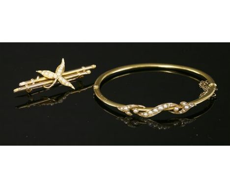A 15ct gold Victorian split pearl hinged bangle, with applied foliate scroll, grain set with split pearls, a hollow chevron s