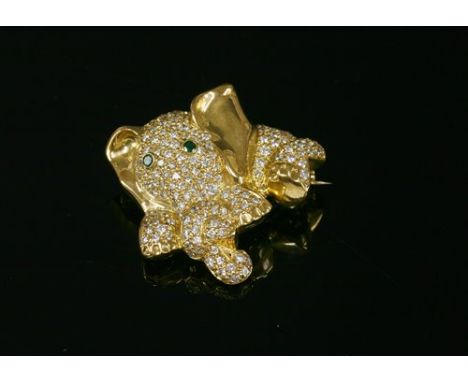 A gold, emerald and diamond set novelty elephant brooch, attributed to David Morris, the elephant with a knot in its trunk, p