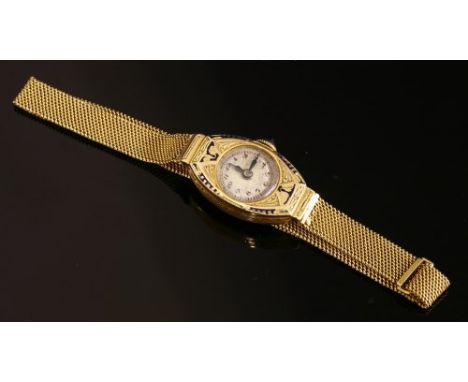A ladies' 18ct gold Art Deco mechanical bracelet watch, with enamel decoration. A tonneau-shaped case with a circular silvere