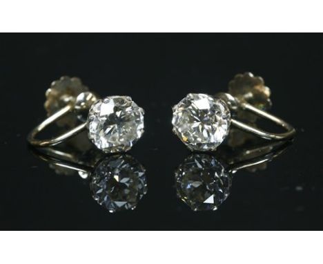 A pair of single stone diamond stud earrings, with later screw fittings, each brilliant cut diamond eight claw set to a sea s