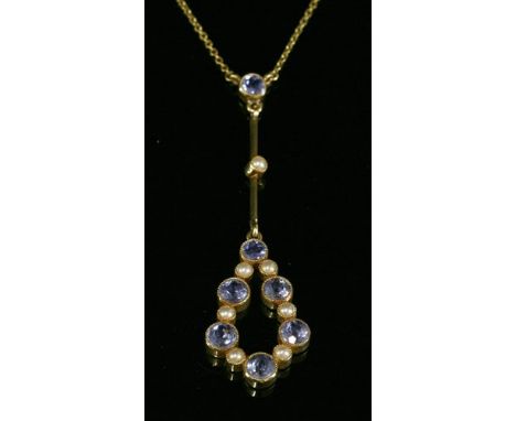 An Edwardian gold, sapphire and split pearl Edna May-style pendant, c.1910, a circular mixed cut sapphire, milligrain set to 