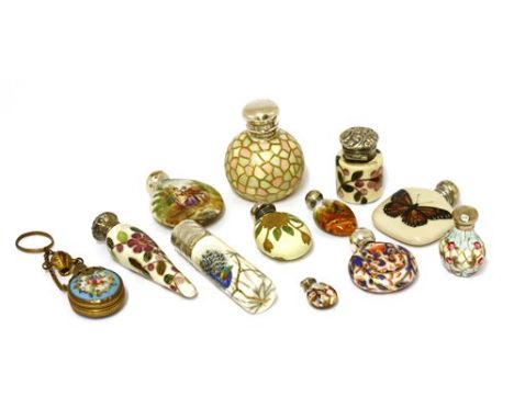 Twelve assorted miniature ceramic scent bottles, to include a silver and cream ceramic scent bottle of oblong form, the cover