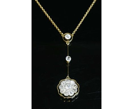 A gold diamond set Edna May pendant, c.1915, with an old European cut diamond, milligrain set in a yellow collet, with a whit