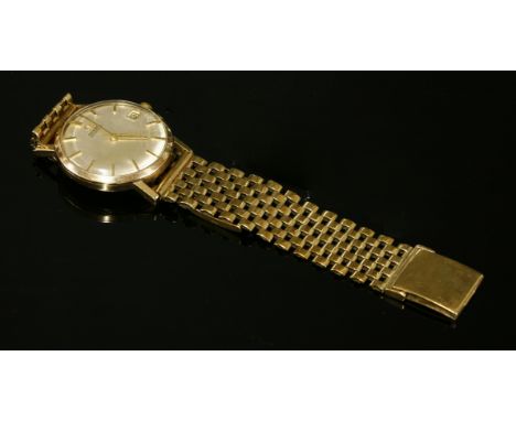 A gentlemen's 9ct gold Omega Automatic watch, c.1963, on a later 9ct gold bracelet. A circular case, 31mm diameter, with a si