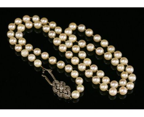 A single row uniform cultured pearl necklace, with a 9ct white gold diamond set clasp. A single row of uniform cultured pearl