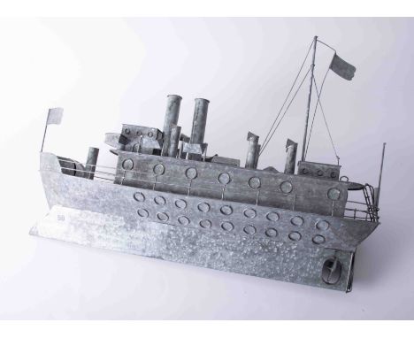 A tin model of a Great War battleship, length 65cm.