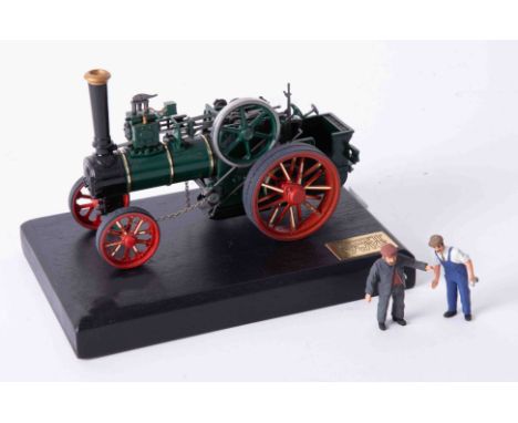 A Bassett Lowke precision scale white metal model of a traction engine, on stand, length 13cm.
