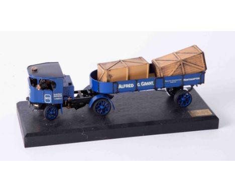A Bassett Lowke precision scale white metal model of a flatbed lorry, on stand, length 22cm.