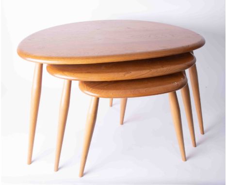 A nest of three Ercol lightwood 'pebble' tables.